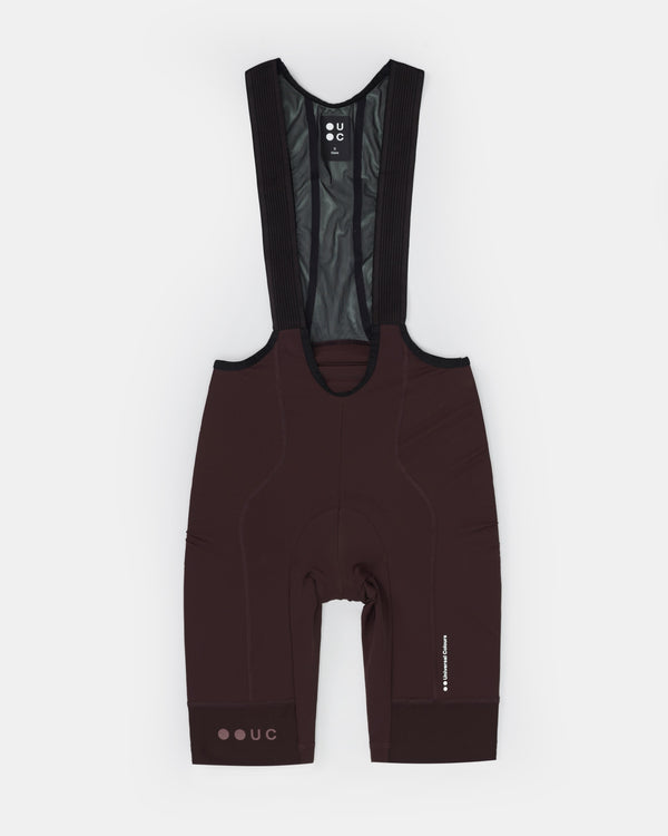Men's Mono Bib Shorts 2.0 in Heavy Bark Brown, flatlay: ribbed black bib straps, mesh upper, chamois and UC neck tab.