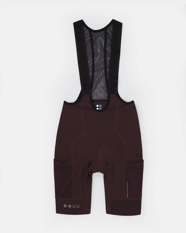 Men's Mono Cargo Bib Shorts in Heavy Bark Brown, front flatlay with mesh bib straps, side cargo pockets and leg UC logo.
