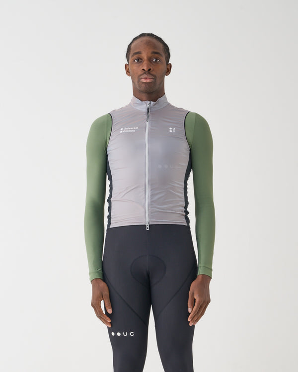Model wearing the Unisex Spectrum Gilet 2.0 in Oyster Blue over a sage green base layer and black UC bib tights.