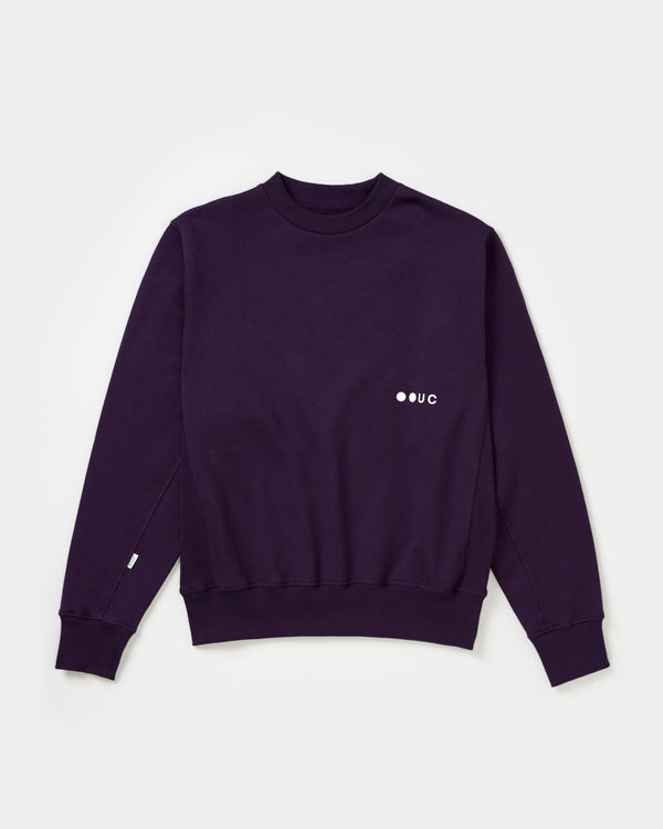 Unisex Sweatshirt in Hard Purple, front flatlay: ribbed crew neck, side panel ribbing and tonal white UC chest logo.