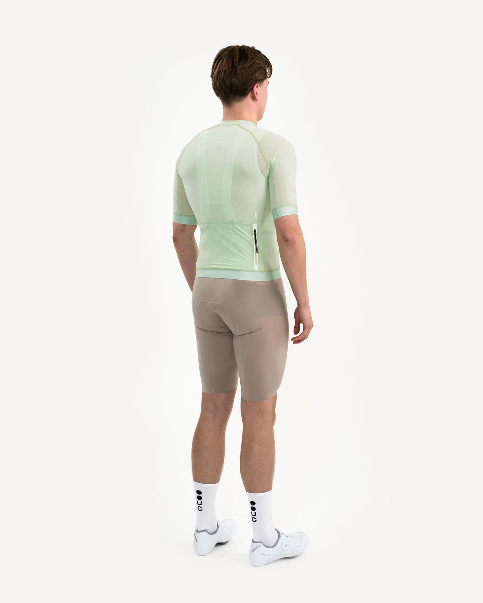 Three-quarter back of the Bower Green Chroma Light Jersey, tonal 'Chroma' wordmark above the rear zip pocket.