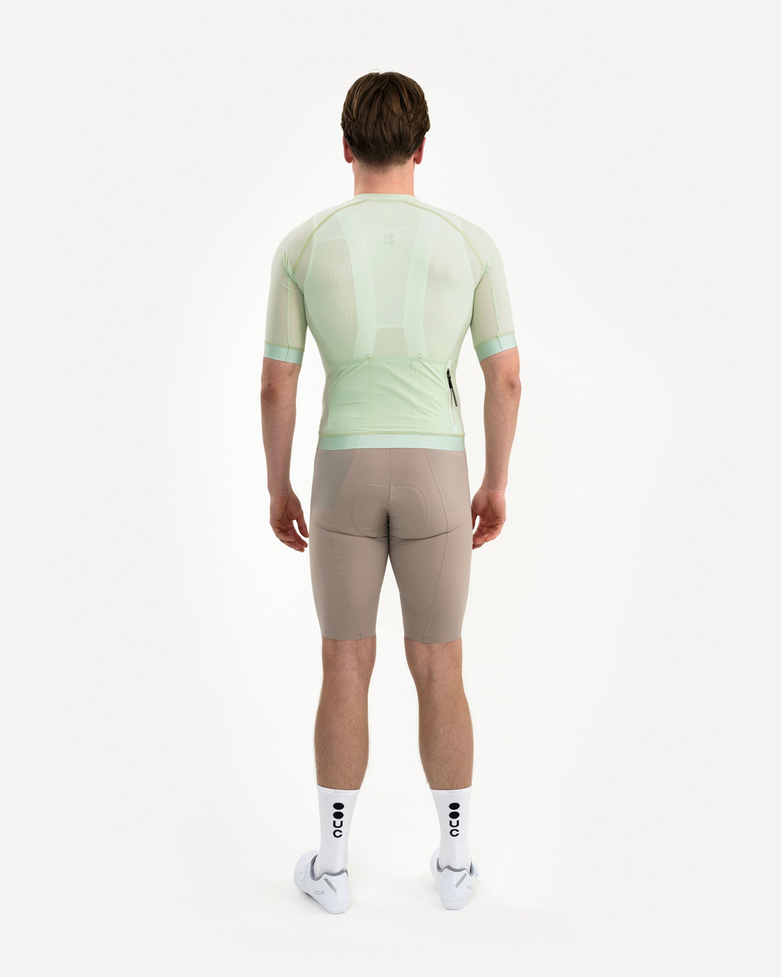 Back view: Men's Chroma Light Jersey in Bower Green showing sheer ripstop fabric and a zipped right-hip pocket.