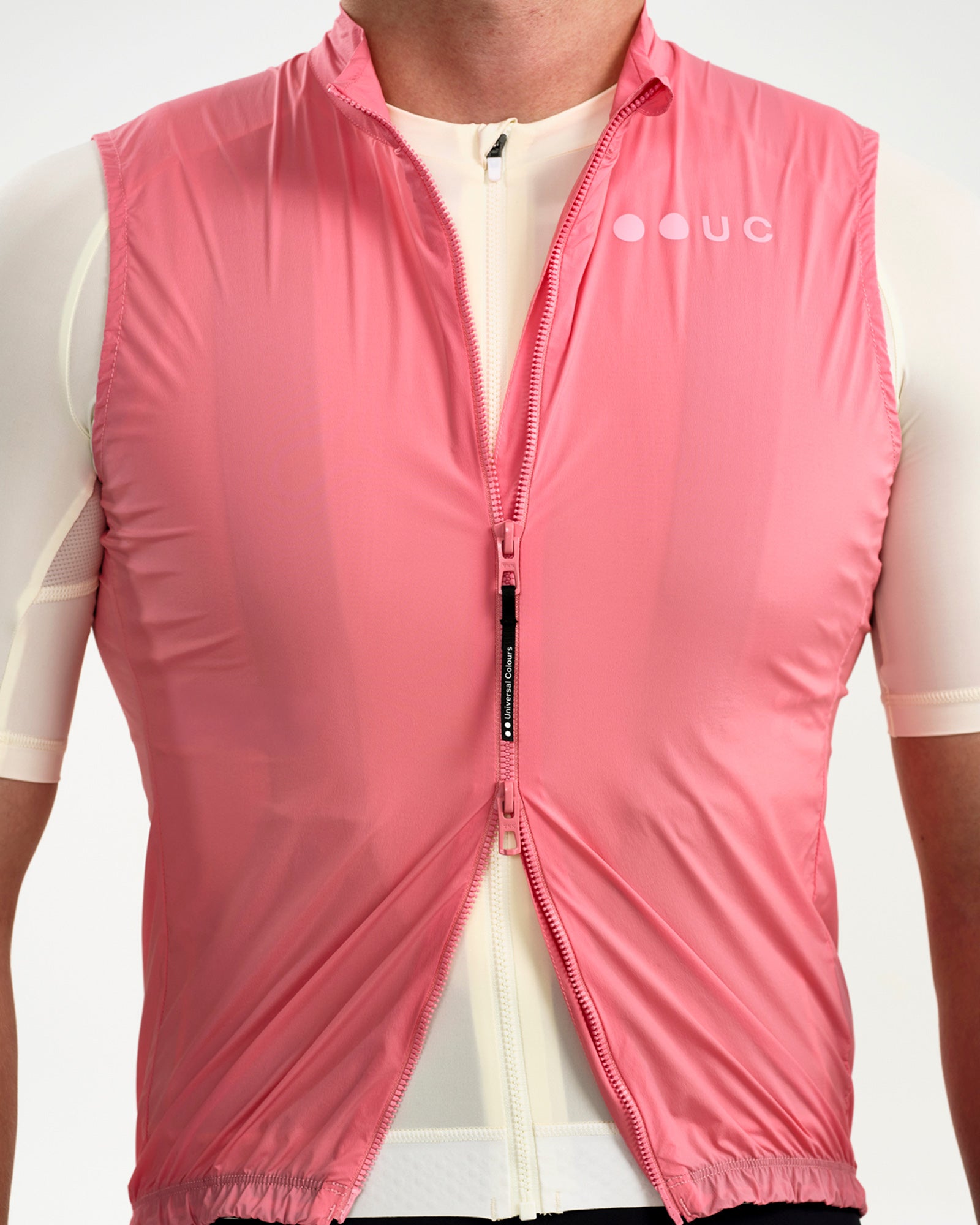 Men's Mono Gilet 2.0 in Washed Pink unzipped to mid-chest, revealing the cream jersey layer beneath and zip garage tab.