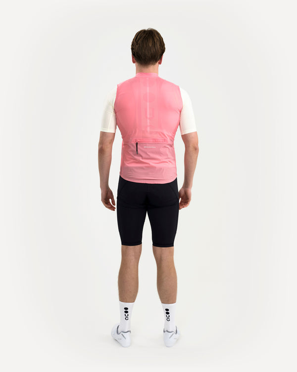 Back view: Men's Mono Gilet 2.0 in Washed Pink over cream short-sleeve jersey, with tonal perforated UC dot wordmark.