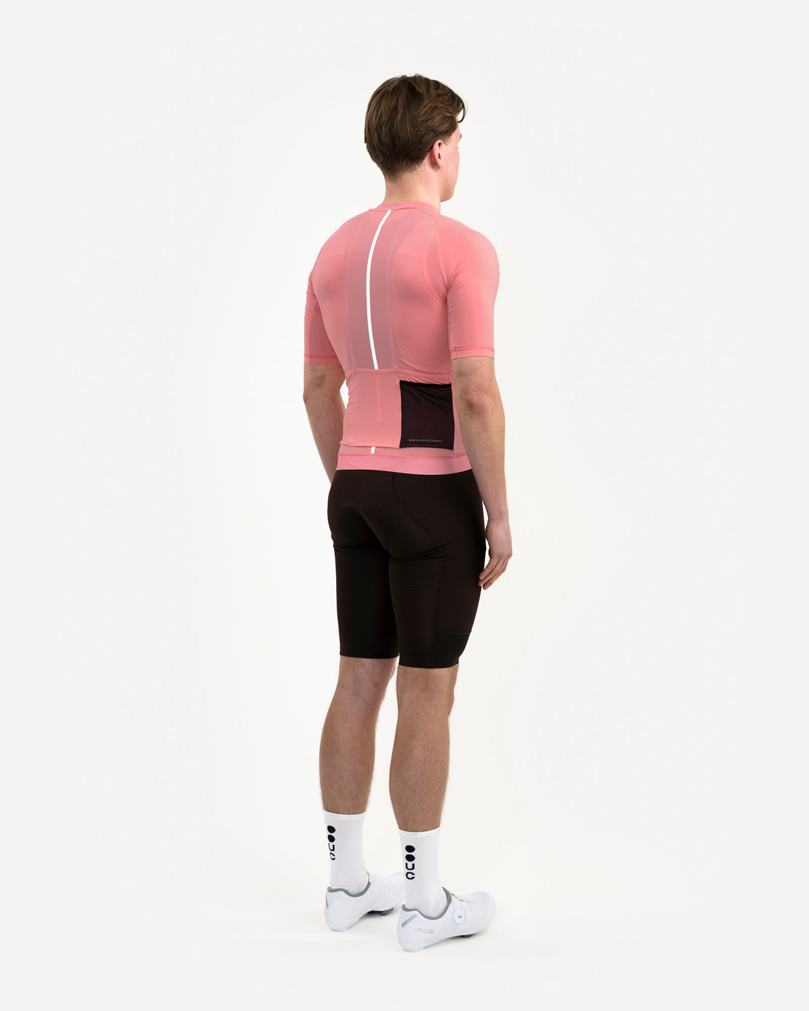 Three-quarter back view of the Men's Mono Short Sleeve Jersey in Pink, side stash pocket extended to show storage capacity.