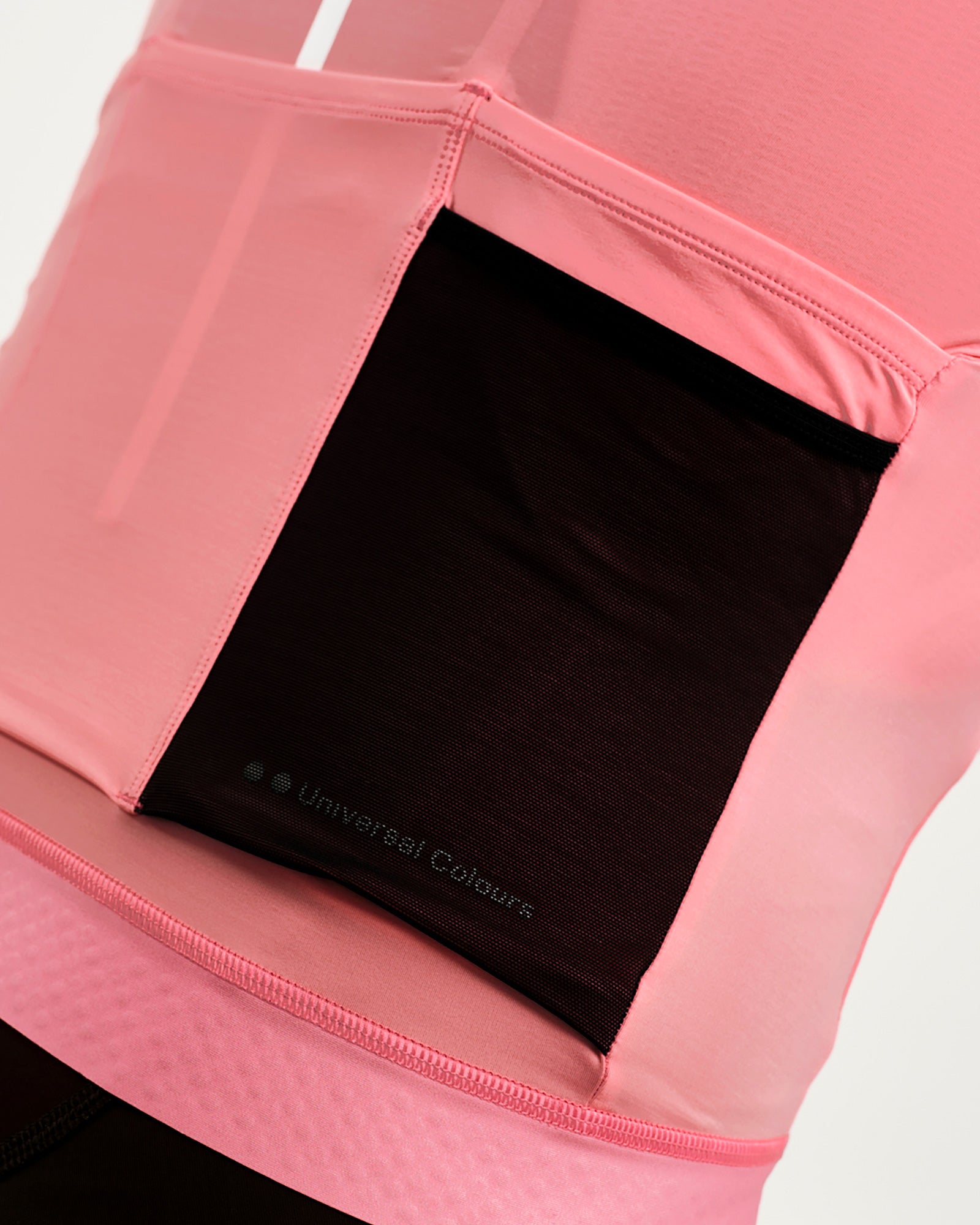 Side stash pocket on the Men's Mono Short Sleeve Jersey in Pink: black mesh panel with tonal Universal Colours print.