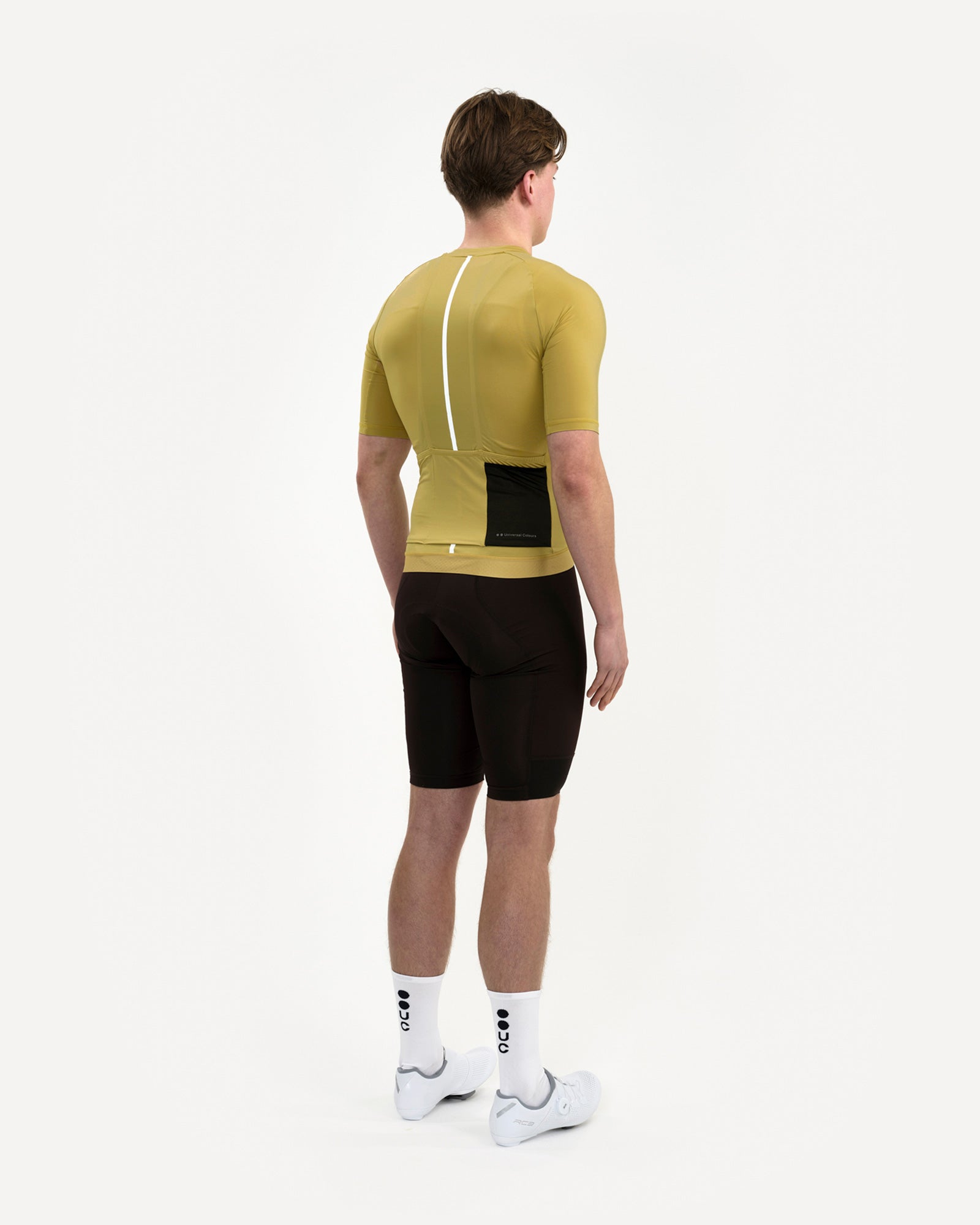 Three-quarter back view of the Men's Mono Short Sleeve Jersey in Acidic Yellow, paired with black bib shorts and UC socks.