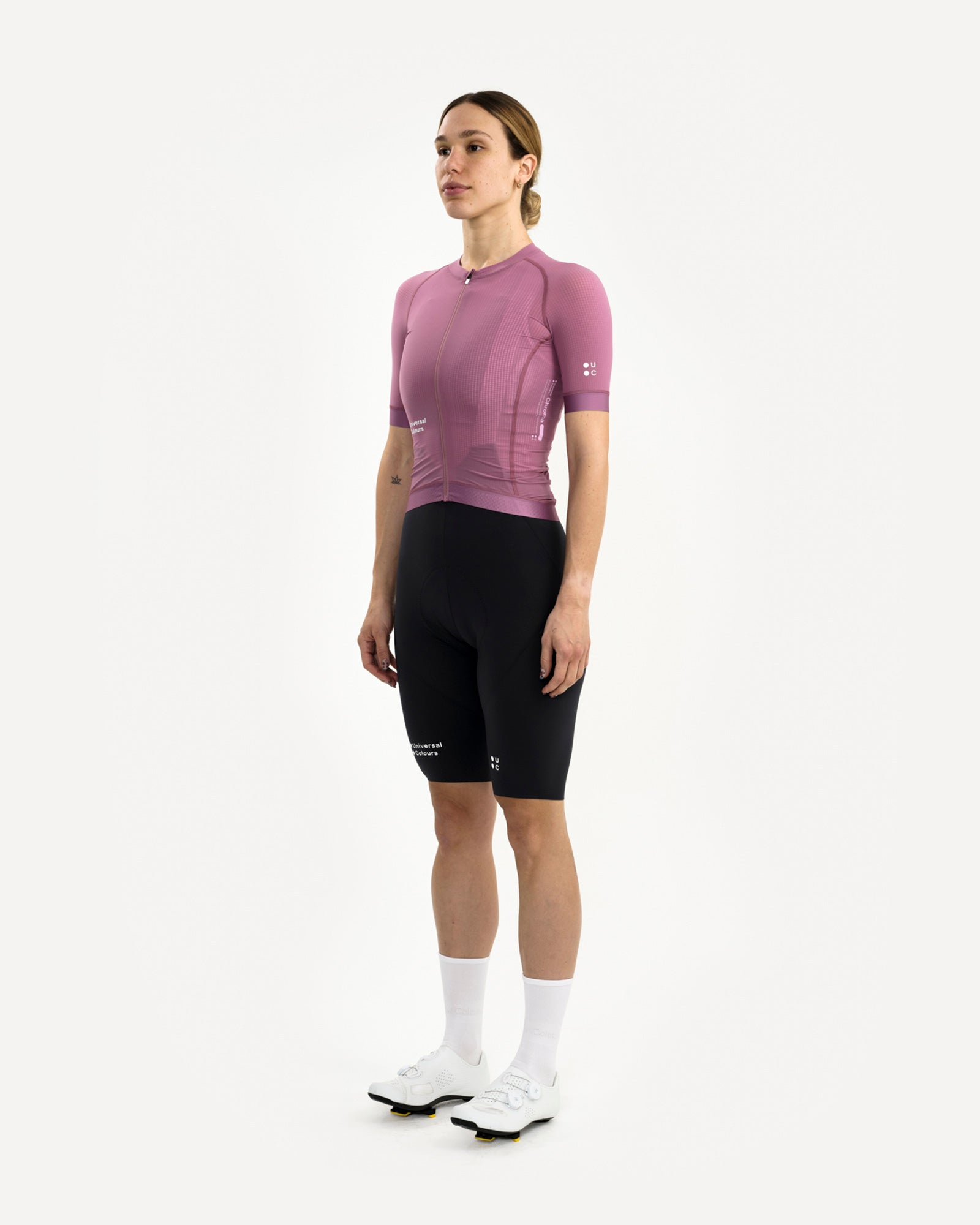 Three-quarter front view: model in the Women's Chroma Light Jersey in Dusty Lilac, paired with black UC bib shorts.