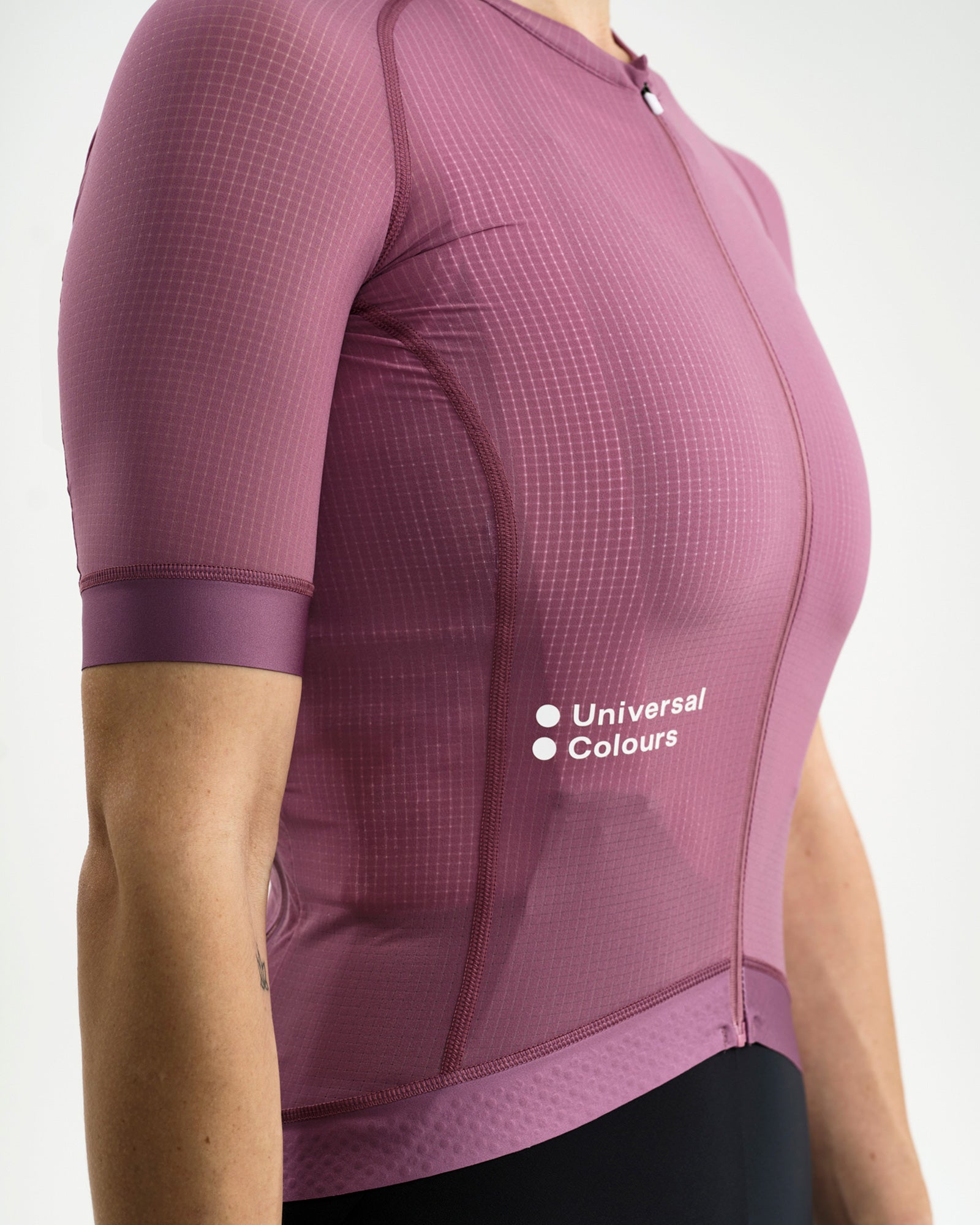 Side close-up: ripstop grid fabric and Universal Colours chest wordmark on the Women's Chroma Light Jersey in Dusty Lilac.