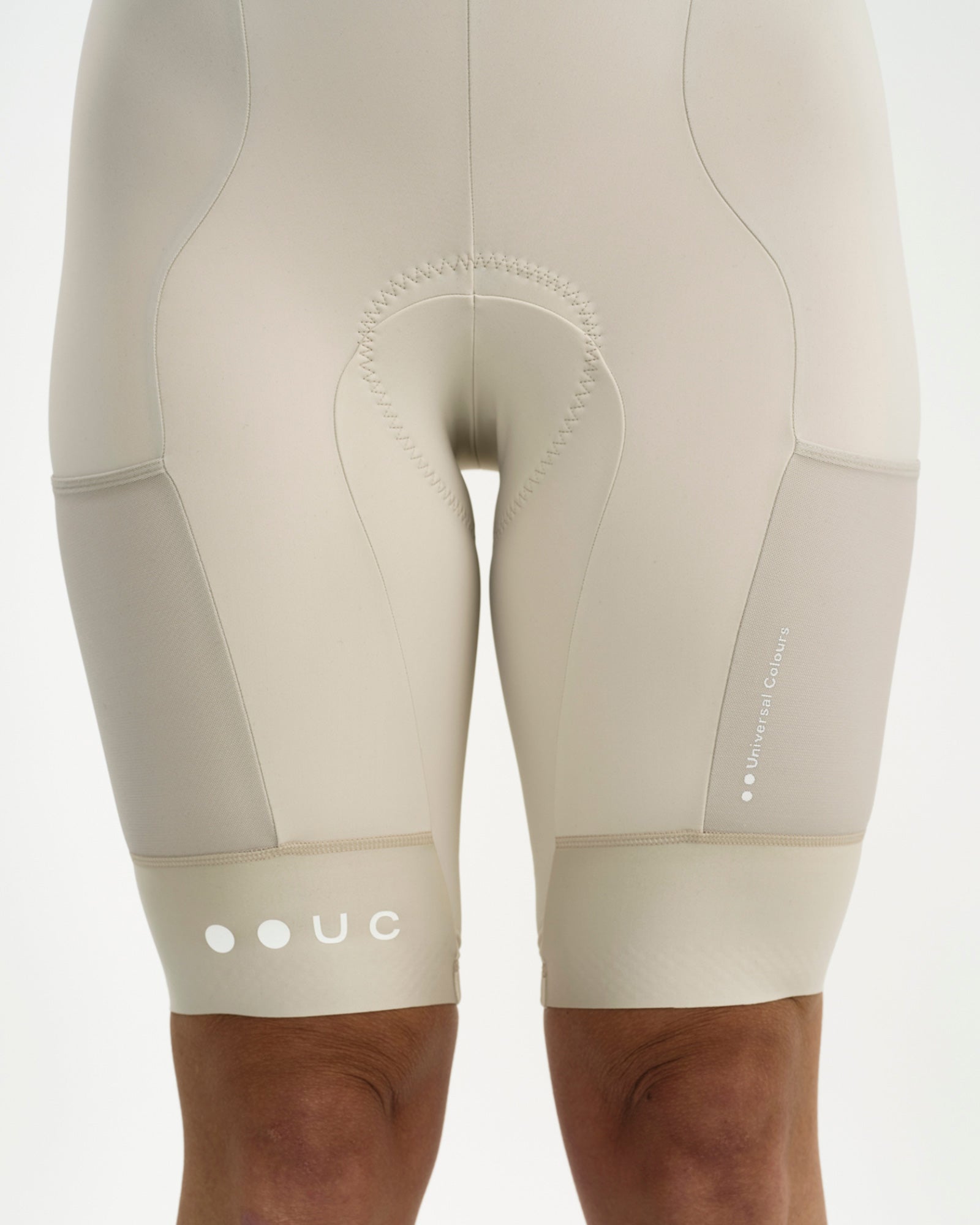 Chamois and mesh side cargo pockets on the Women's Mono Cargo Bib Short in Off White, with tonal Universal Colours wordmark.