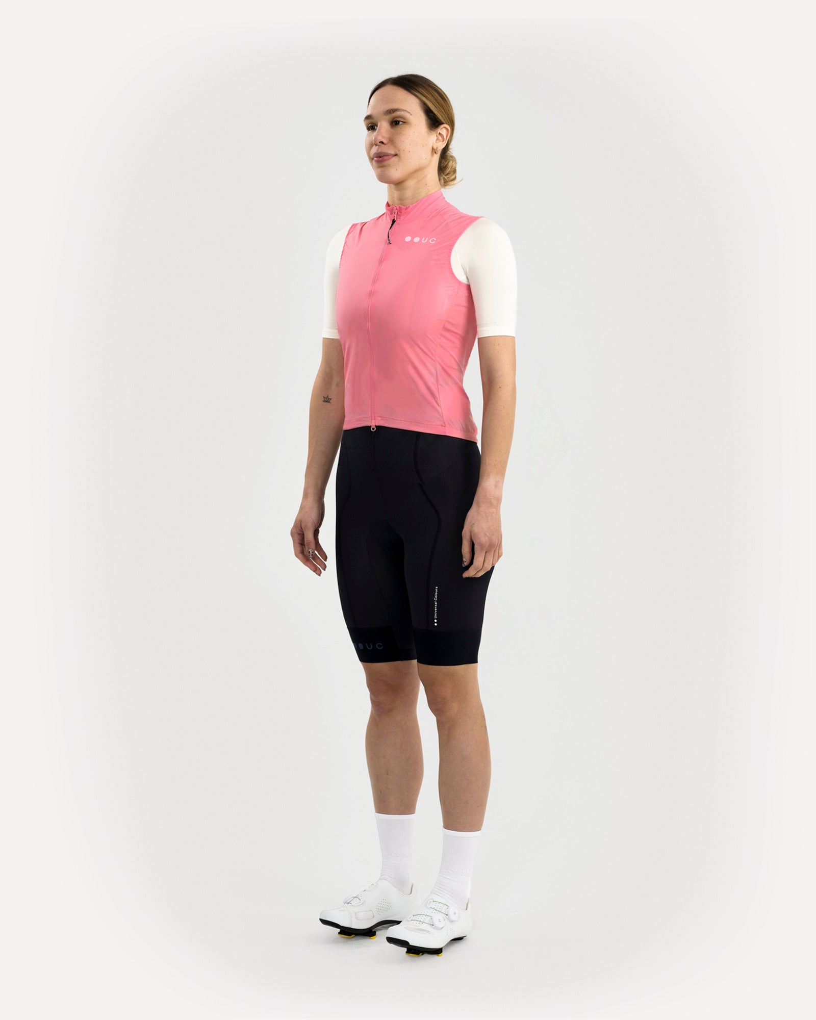 Three-quarter front view: model wears the Women's Mono Gilet 2.0 in Washed Pink with a cream jersey and black UC bib shorts.