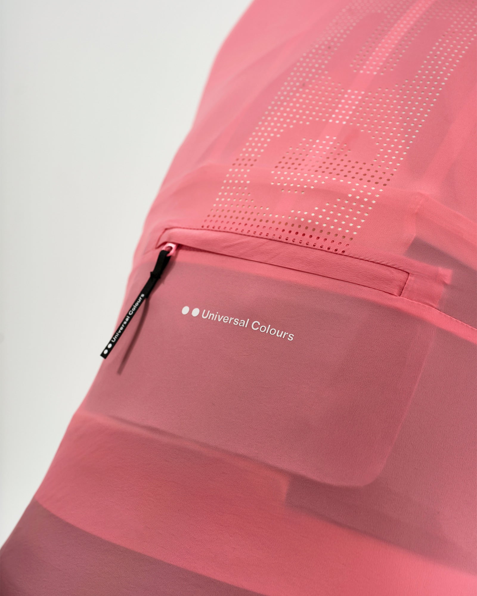 Rear pocket detail on the Washed Pink Women's Mono Gilet 2.0: zipped stash pocket and tonal Universal Colours wordmark.