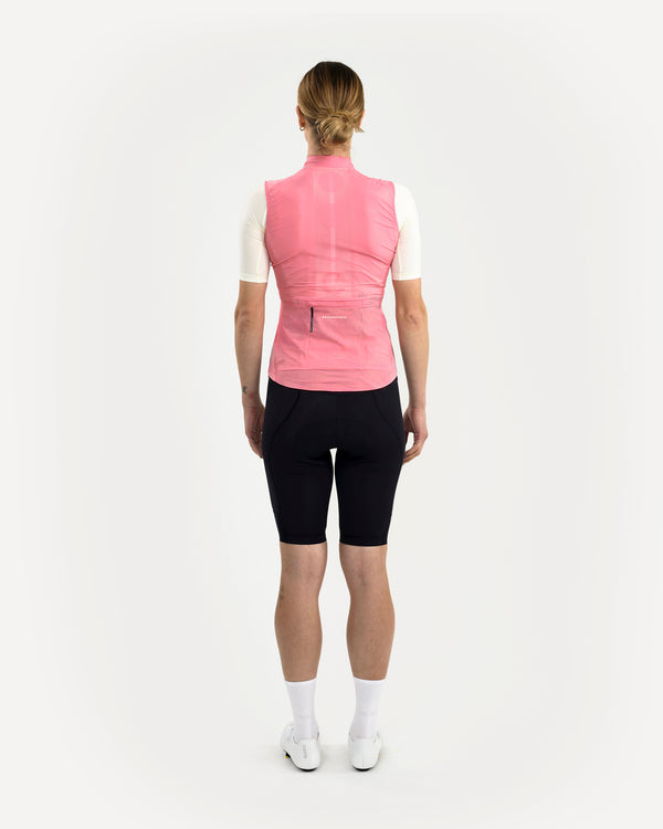 Back view of the Women's Mono Gilet 2.0 in Washed Pink, layered over a cream jersey with perforated mesh back panel visible.