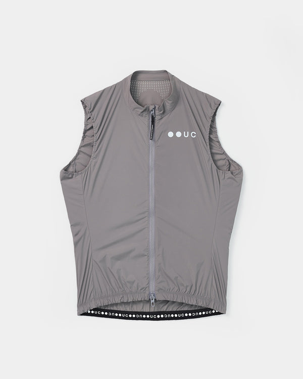Flatlay of the Women's Mono Gilet 2.0 in Shoot Grey: full-length zip, tonal UC chest logo and 'uc' wordmark hem tape.