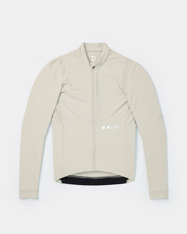 Flatlay of the Men's Mono Long Sleeve Jersey in Stone White: mock collar, full-length zip and white UC chest logo.