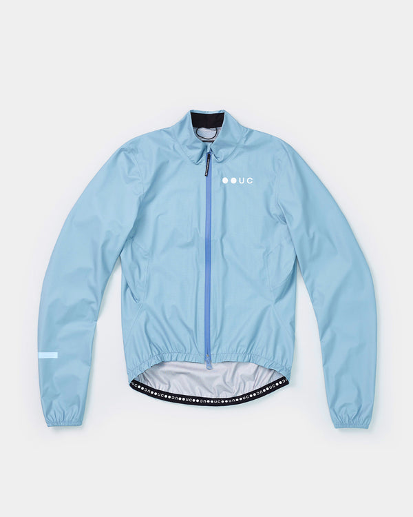 Women's Mono Rain Jacket in Isabel Blue, flatlay front view, full-length blue zip and tonal UC chest logo.