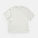 Flatlay of the Universal Colours Tech Tee in Off White: crew neck, with pink UC vertical logo on the lower-left front.