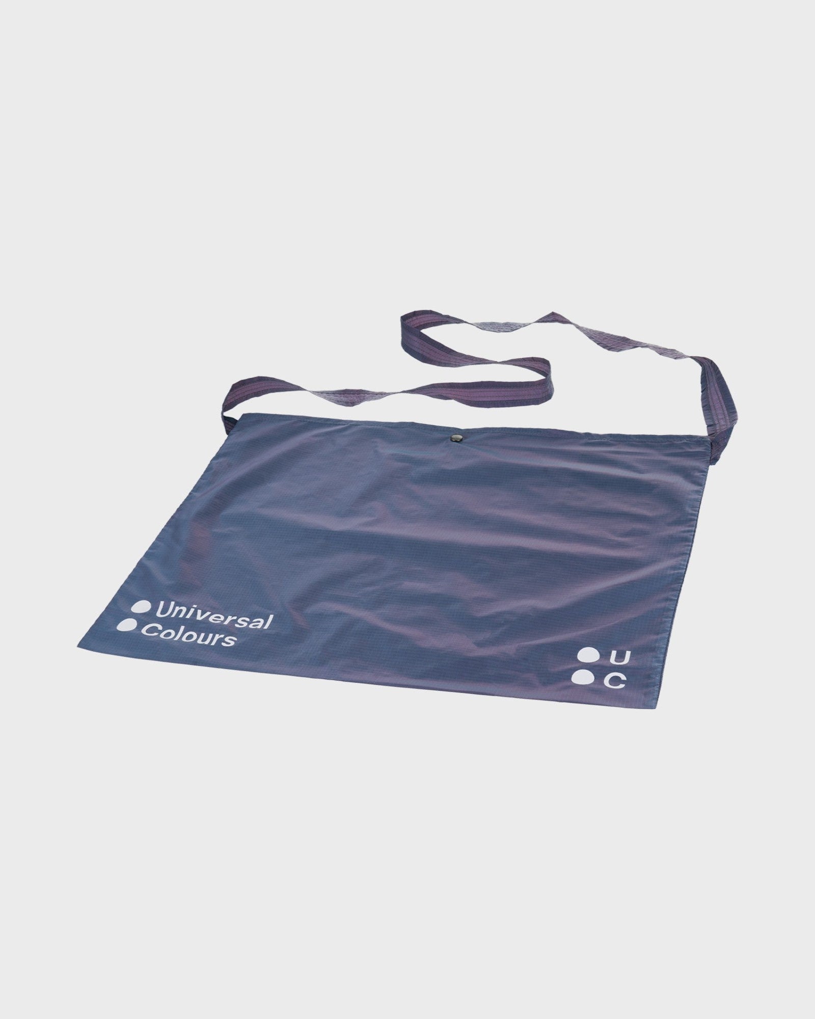 Three-quarter view: Spectrum Musette in Iridescent Violet, ripstop nylon shimmering blue-purple with looped shoulder strap.