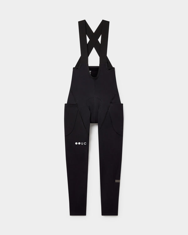 Women's Mono Cargo Bib Tight in Black, flatlay front view: crossover straps and twin stretch thigh cargo pockets.