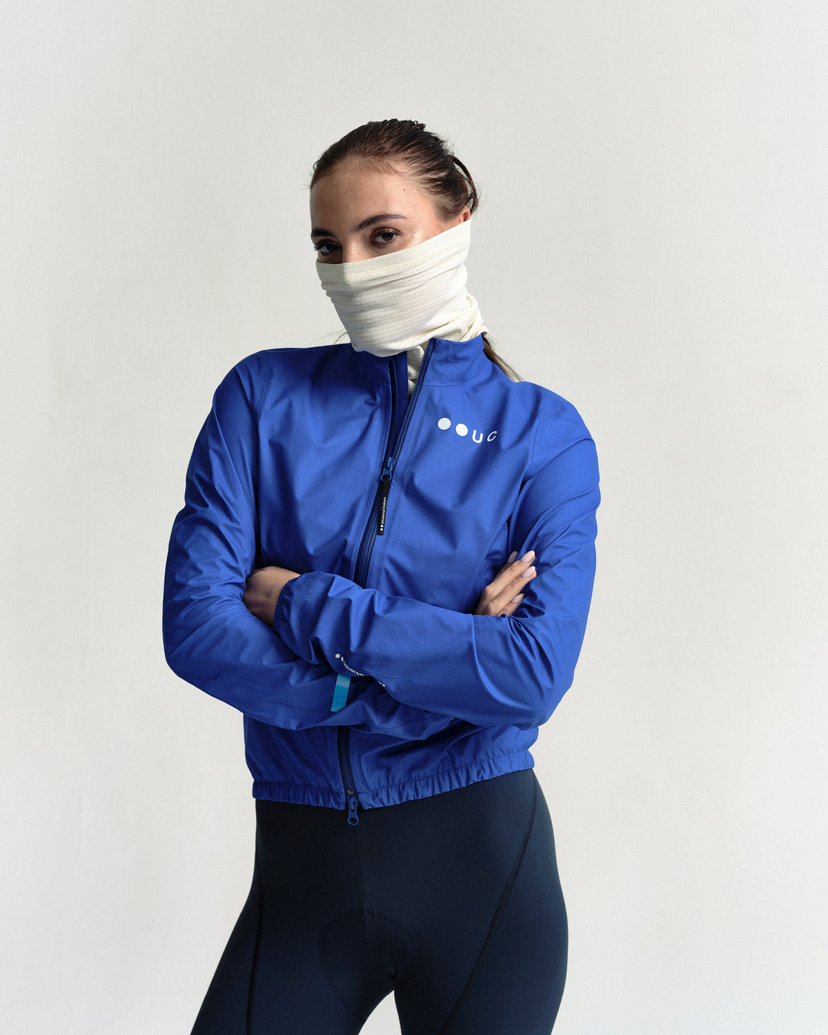 Model in the Polartec Neck Warmer in Off White, full-length view.