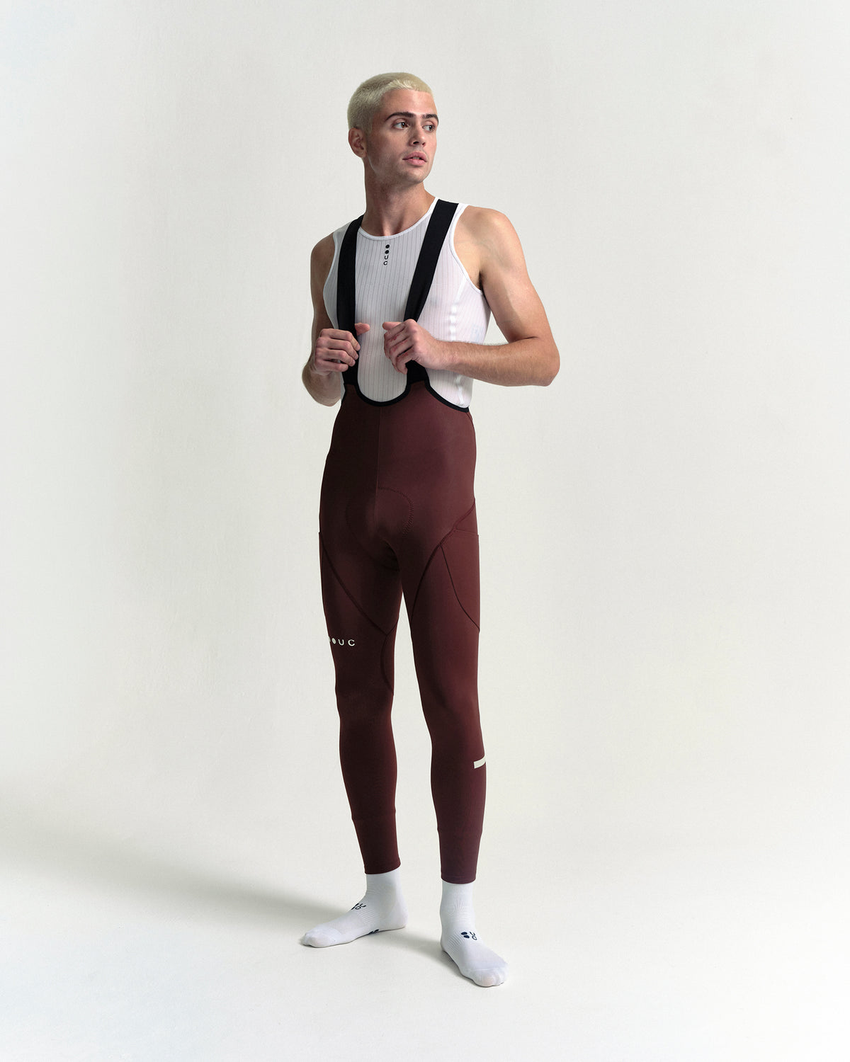 Model wearing the Men's Mono Cargo Bib Tight in Deep Red.
