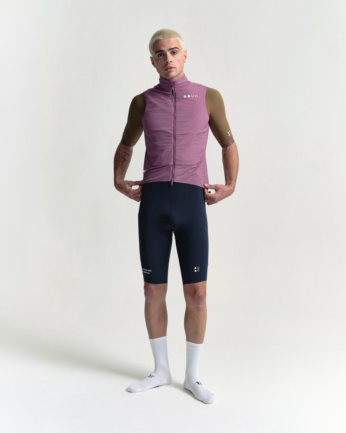 Model in the Men's Chroma Insulated Gilet in Dusty Rose, full-length view.