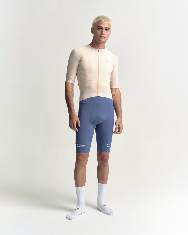 Model in the Men's Chroma Short Sleeve Jersey in Almond, full-length view.