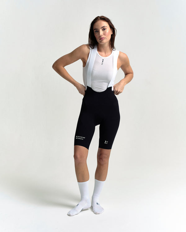 Model in the Women's Chroma Cargo Bib Shorts in Black, full-length view.