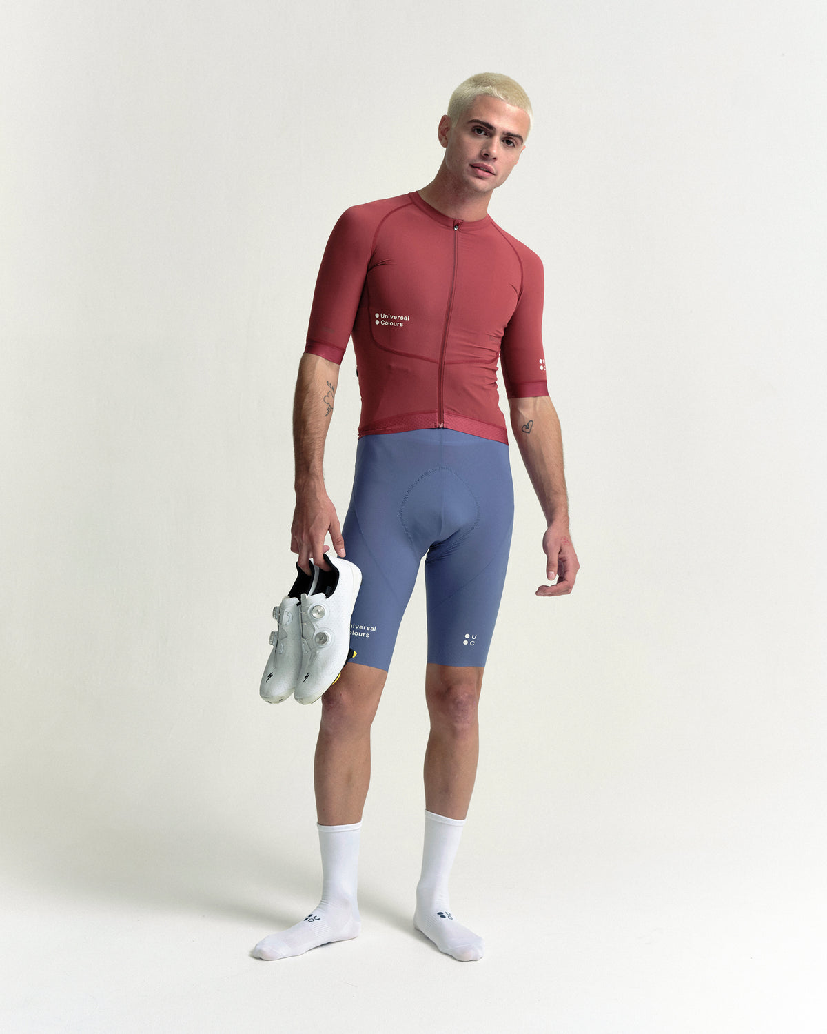 Model in the Men's Chroma Short Sleeve Jersey in Earth Red, full-length view.