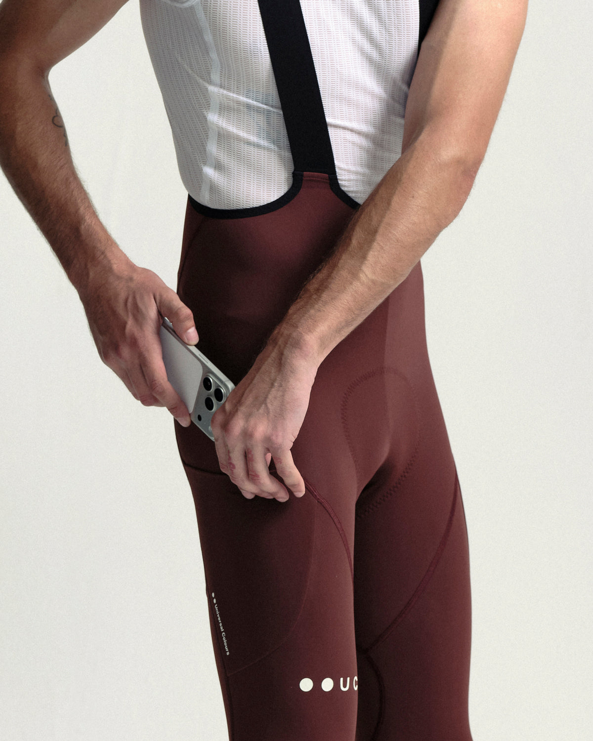 Model wearing the Men's Mono Cargo Bib Tight in Deep Red.