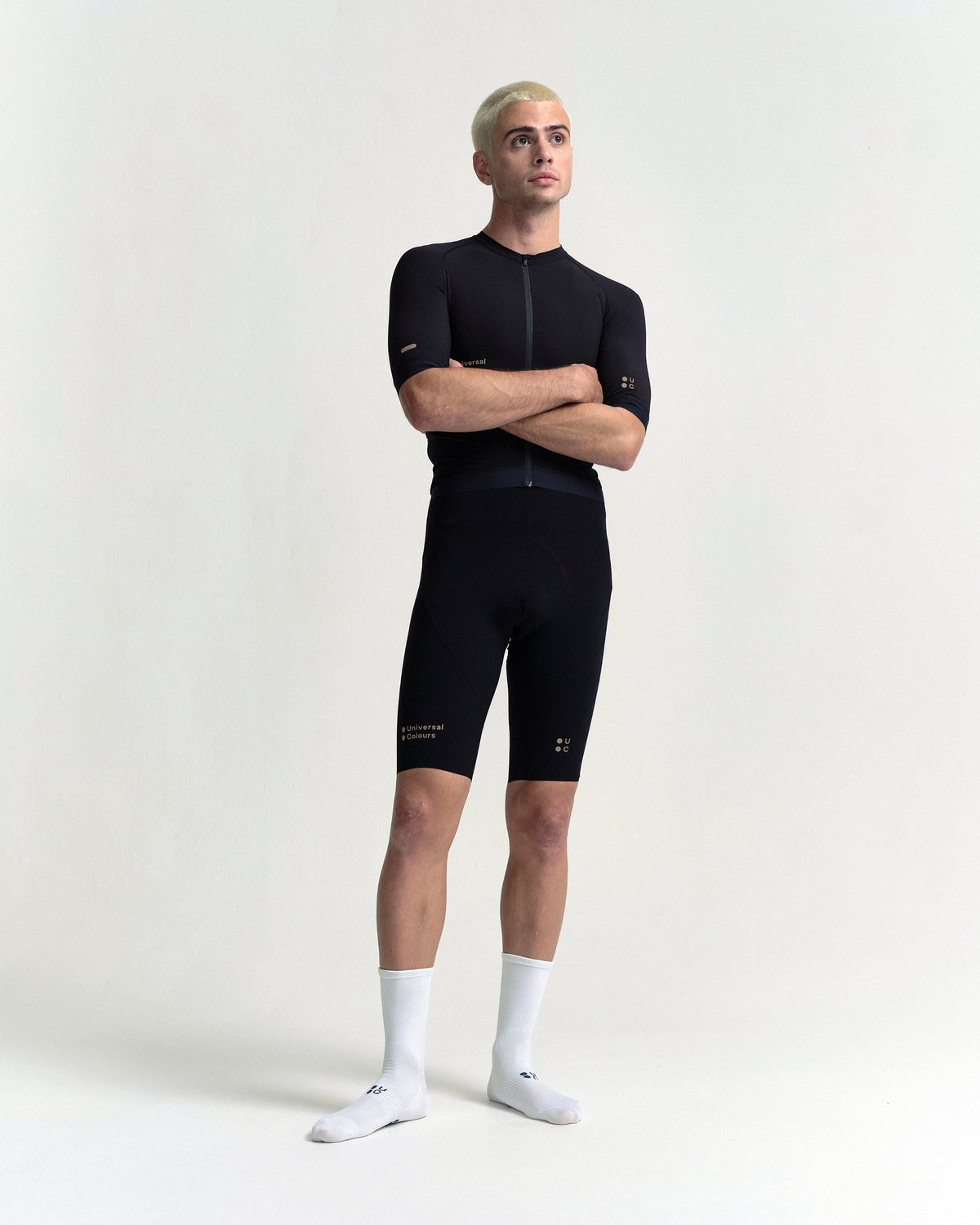 Model in the Men's Chroma Bib Shorts in Black/Bronze, full-length view.