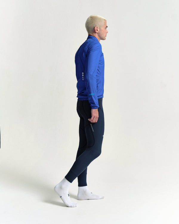 Model in the Men's Mono Rain Jacket in Vivid Blue, full-length view.