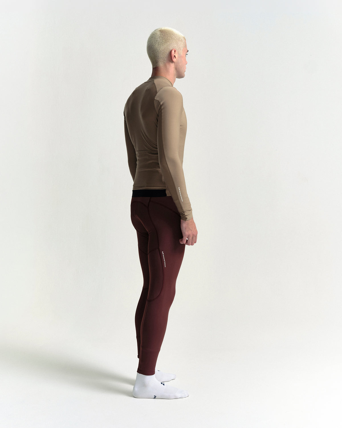 Model in the Men's Mono Long Sleeve Jersey in Walnut Brown, full-length view.