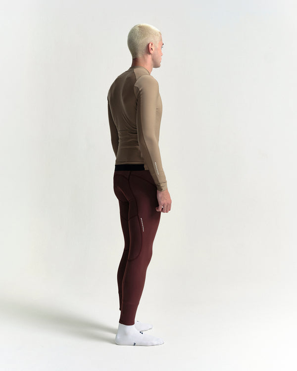 Model in the Men's Mono Long Sleeve Jersey in Walnut Brown, full-length view.