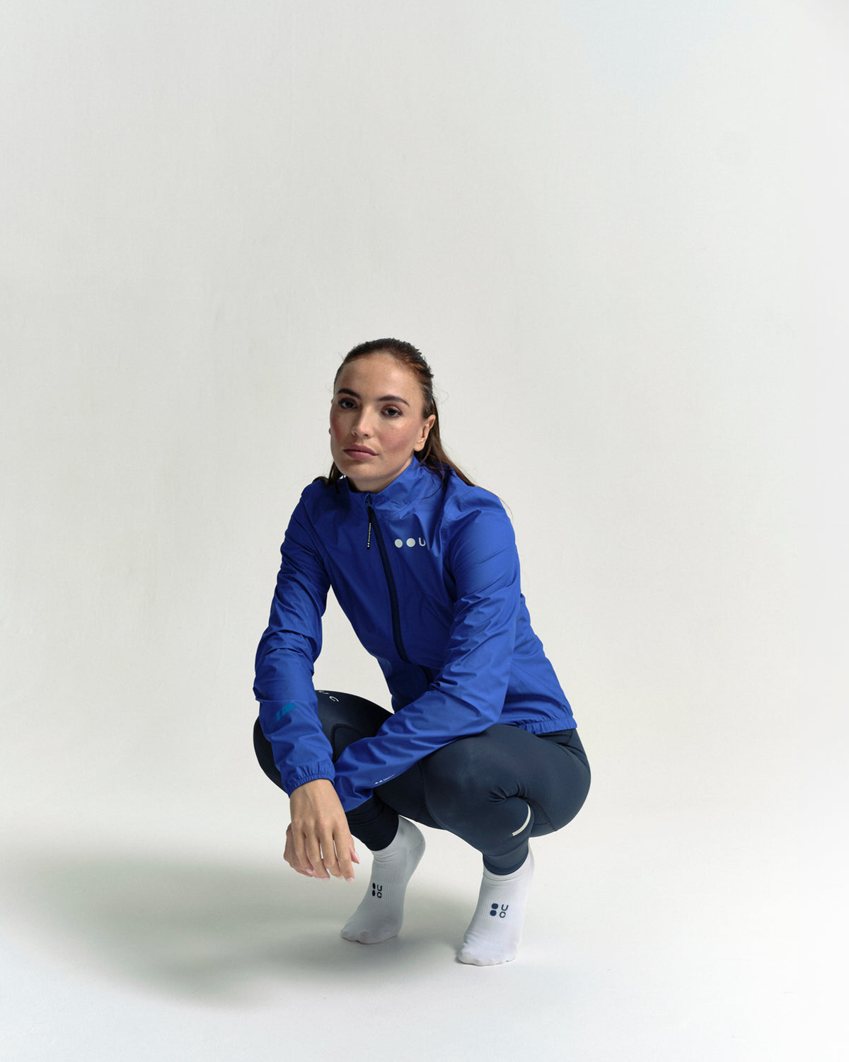 Model wearing the Women's Mono Rain Jacket in Vivid Blue.