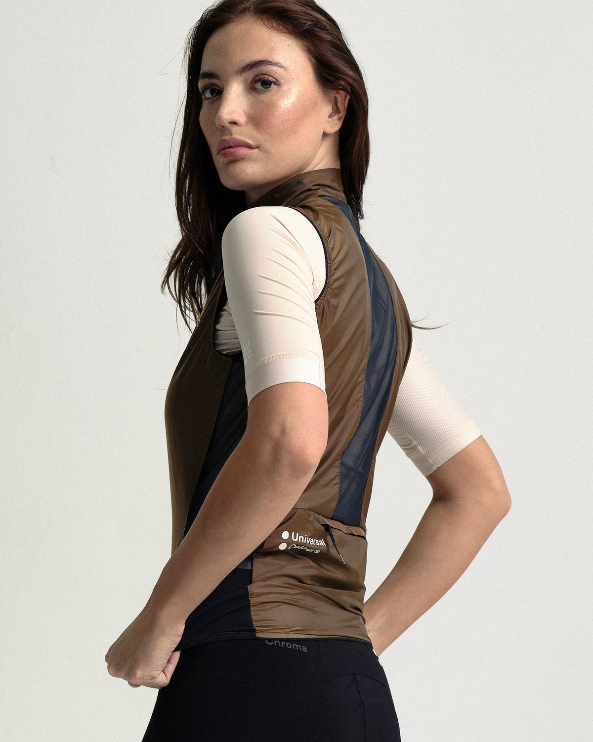 Model wearing the Women's Spectrum Gilet 2.0 in Honey Gold.