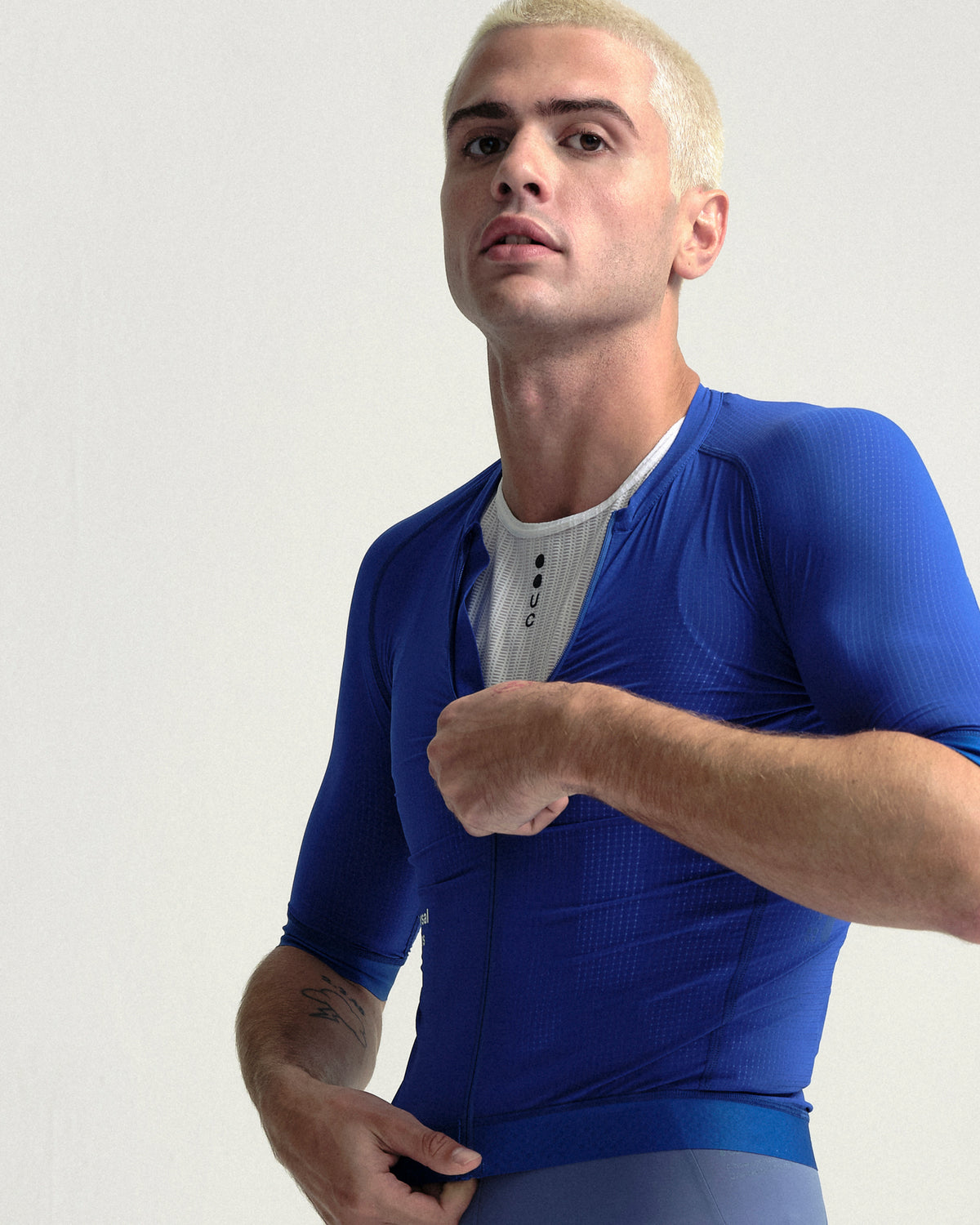 Model wearing the Men's Chroma Light Short Sleeve Jersey in Vivid Blue.