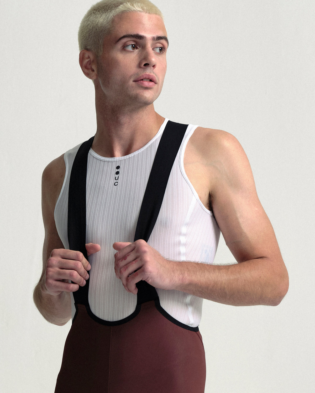 Model wearing the Men's Mono Cargo Bib Tight in Deep Red.