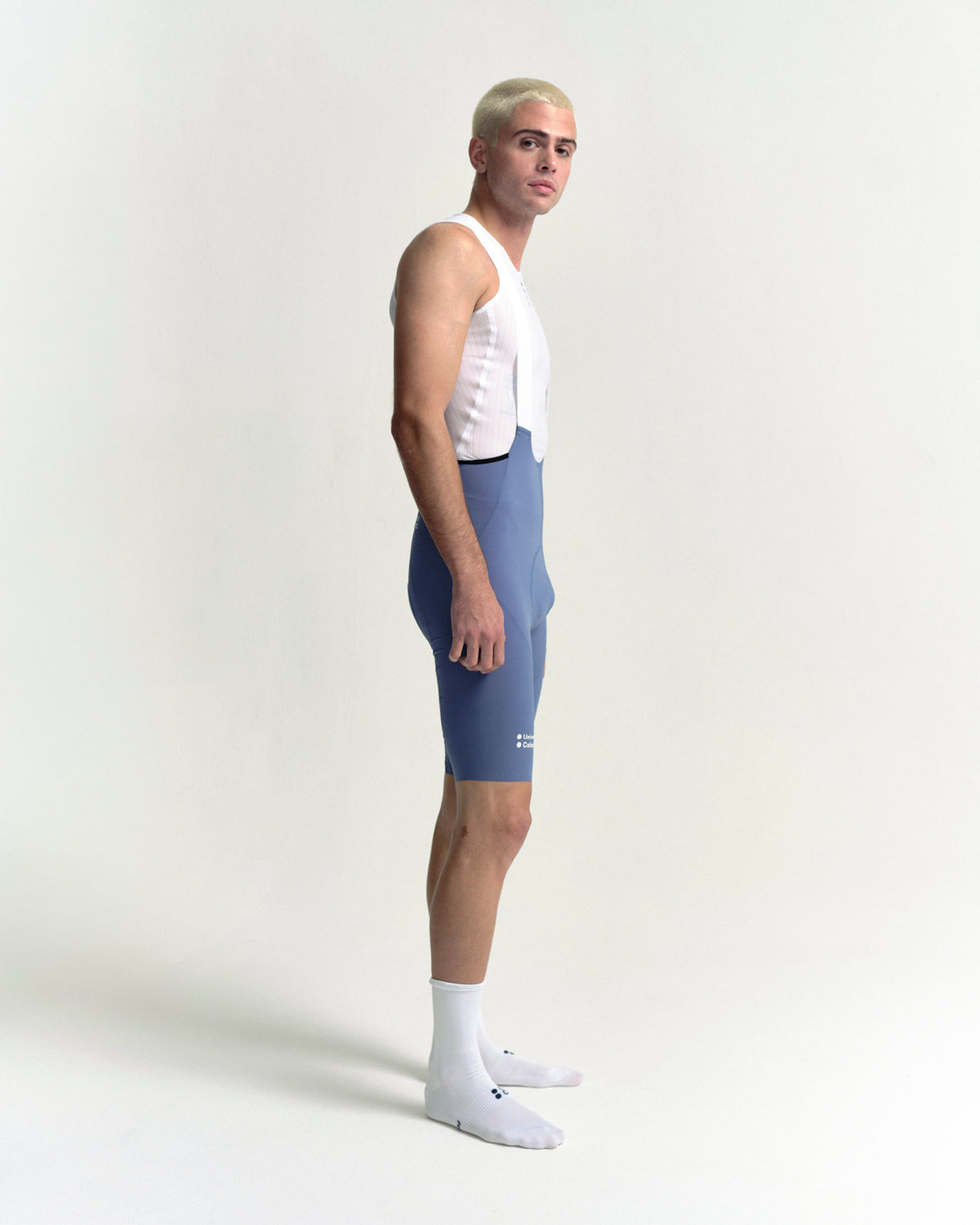 Model in the Men's Chroma Bib Shorts in Slate Blue, side view.