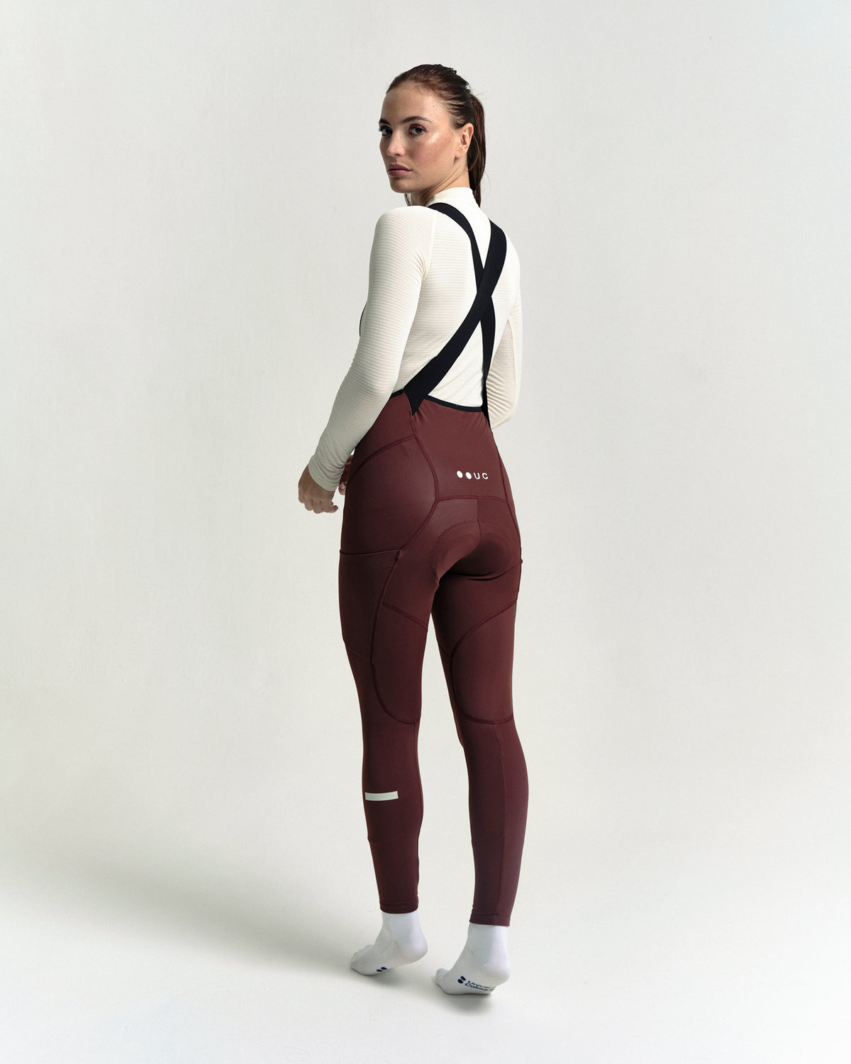 Model in the Women's Mono Cargo Bib Tight in Deep Red, full-length view.