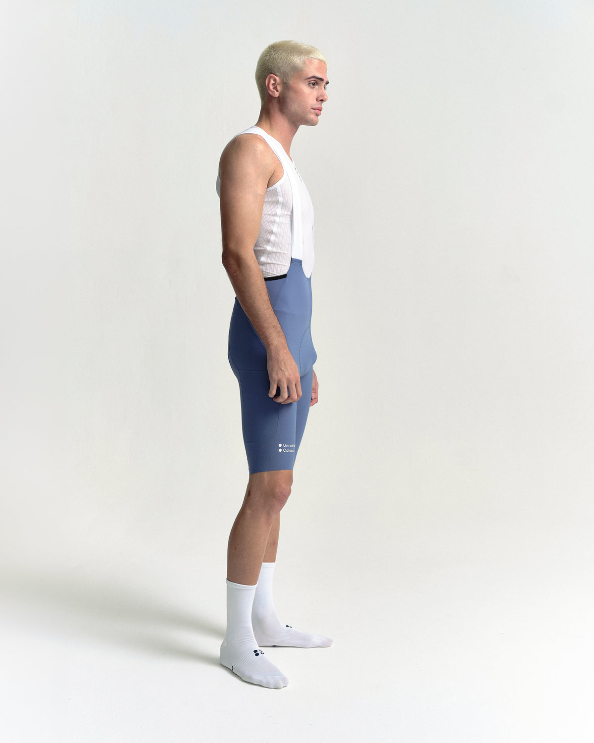 Model wearing the Men's Chroma Cargo Bib Shorts in Slate Blue.