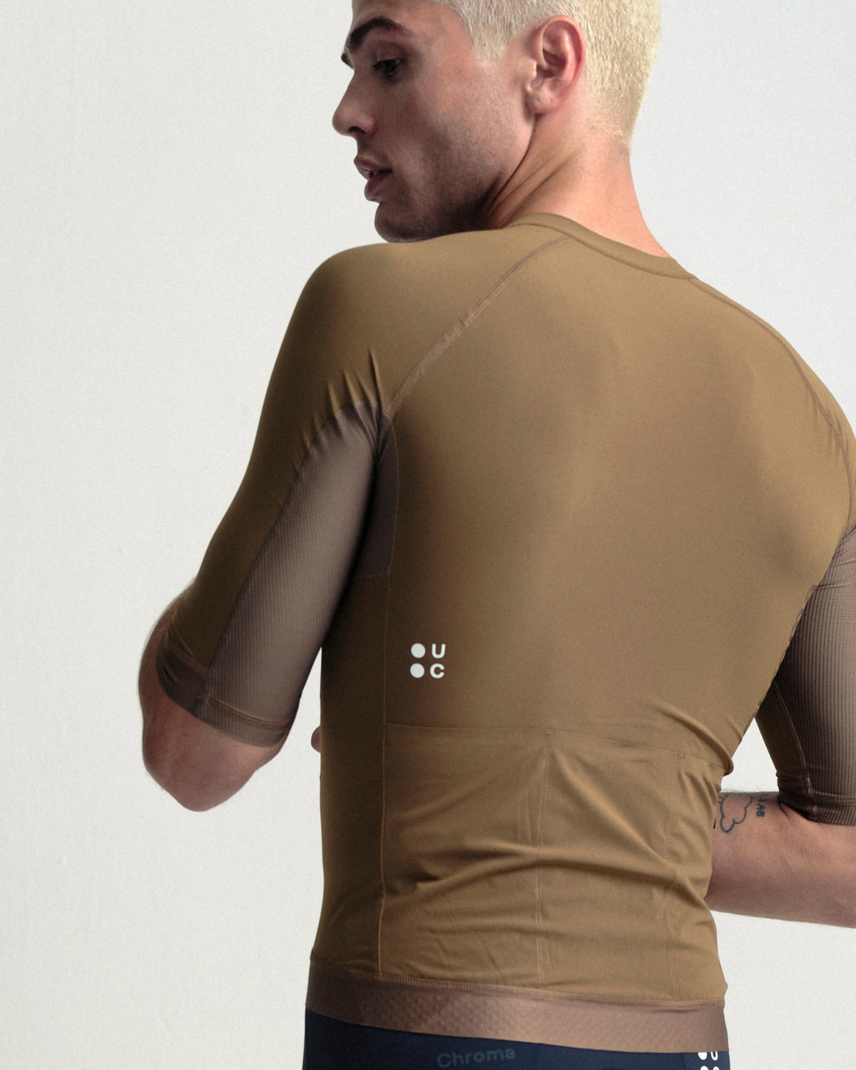 Model wearing the Men's Chroma Short Sleeve Jersey in Golden Brown.