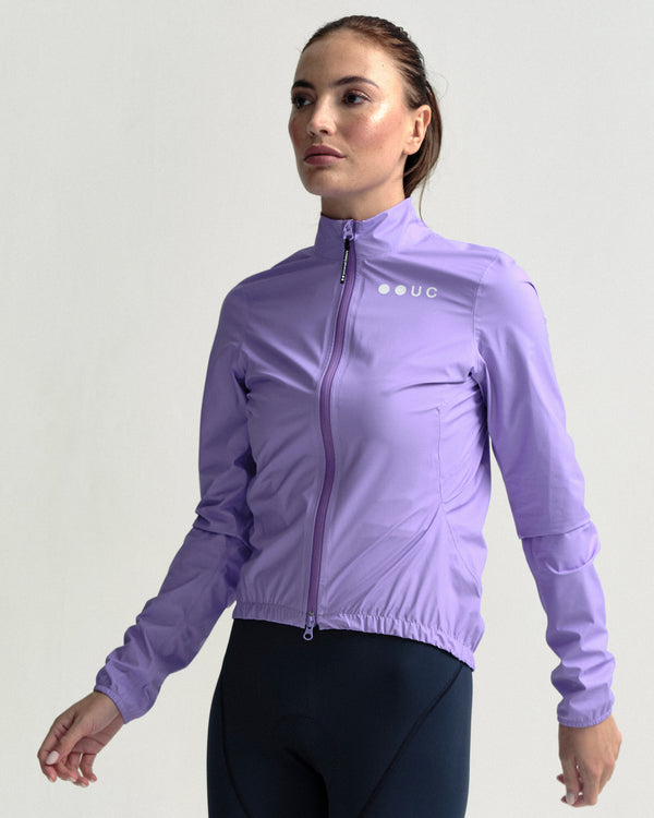 Model mid-stride in the Women's Mono Rain Jacket in Cloud Lilac.