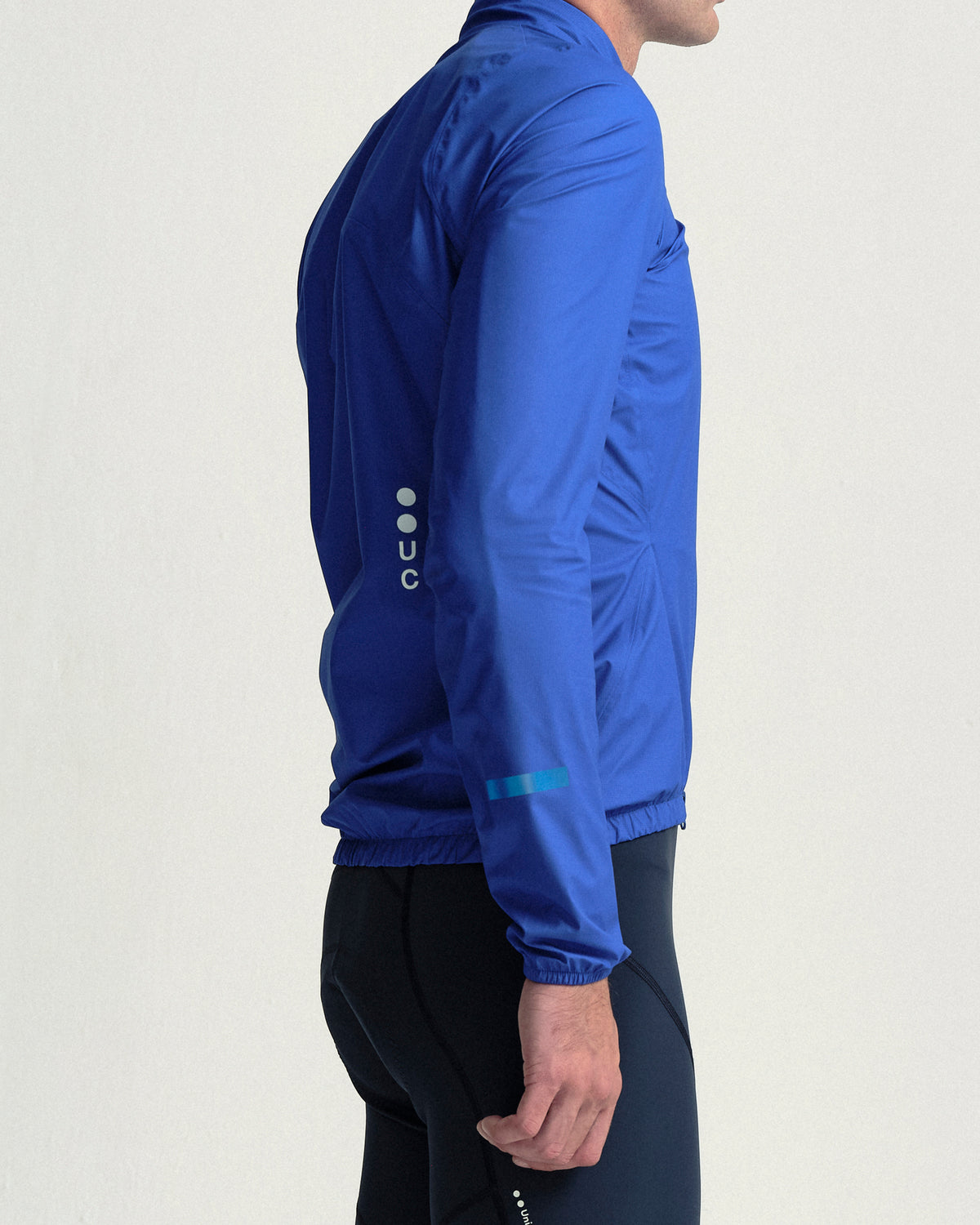 Model wearing the Men's Mono Rain Jacket in Vivid Blue.