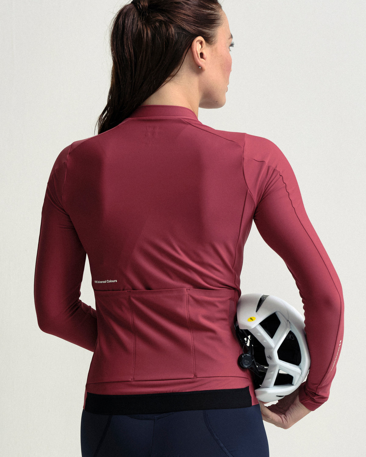 Model wearing the Women's Mono Long Sleeve Jersey in Apple Red.