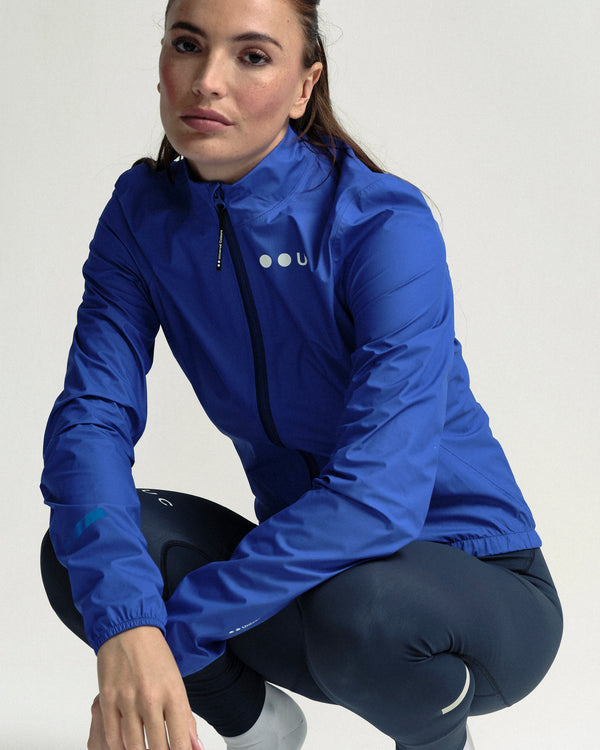 Model in the Women's Mono Rain Jacket in Vivid Blue, full-length view.