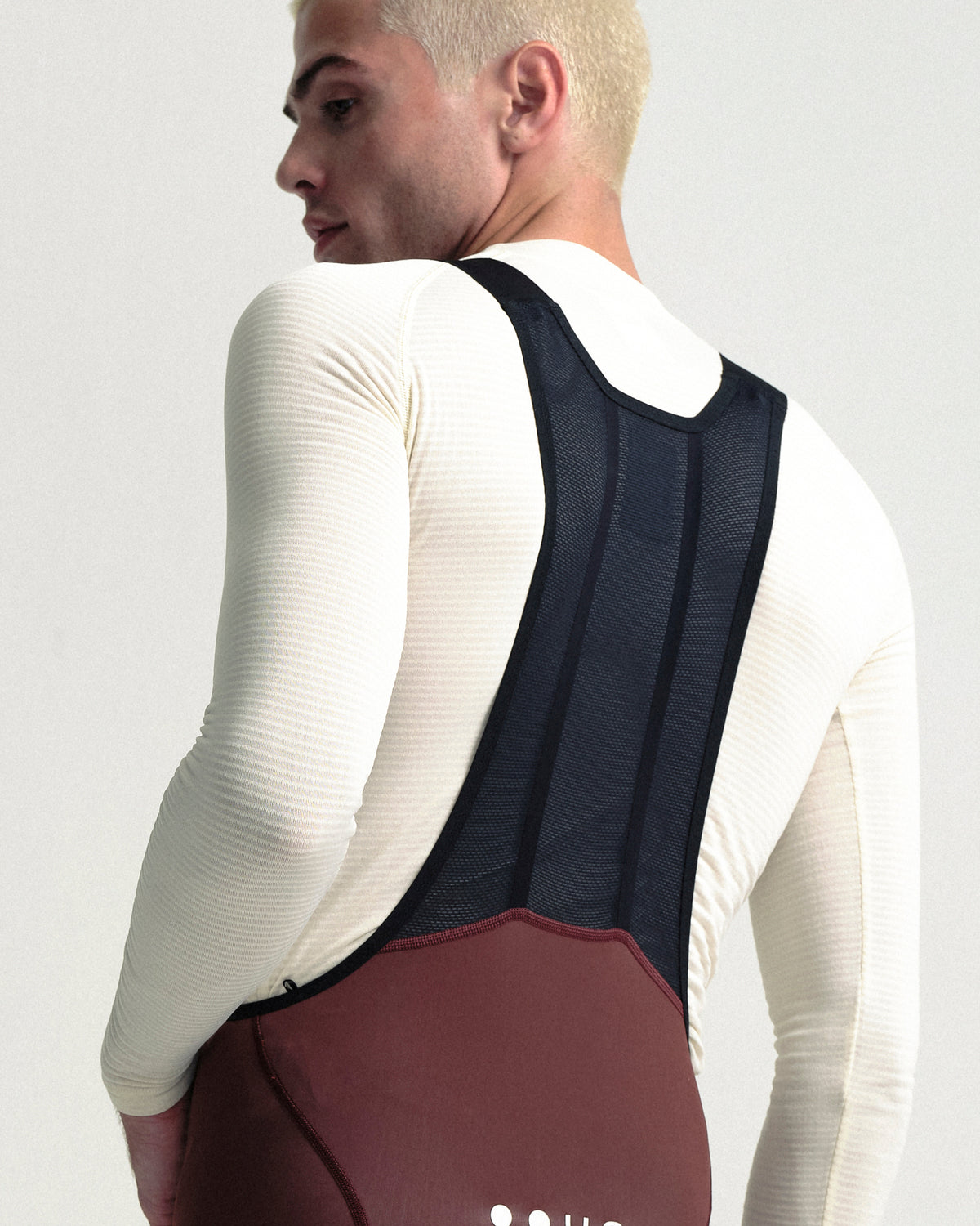 Model wearing the Men's Mono Bib Tight in Deep Red.