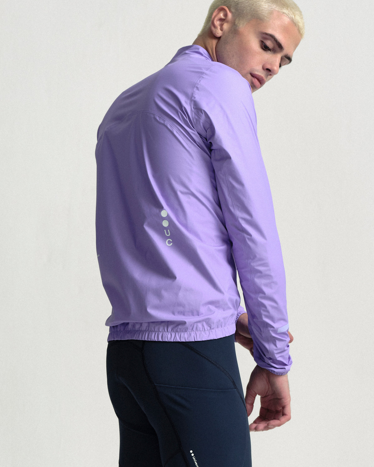 Model wearing the Men's Mono Rain Jacket in Cloud Lilac.