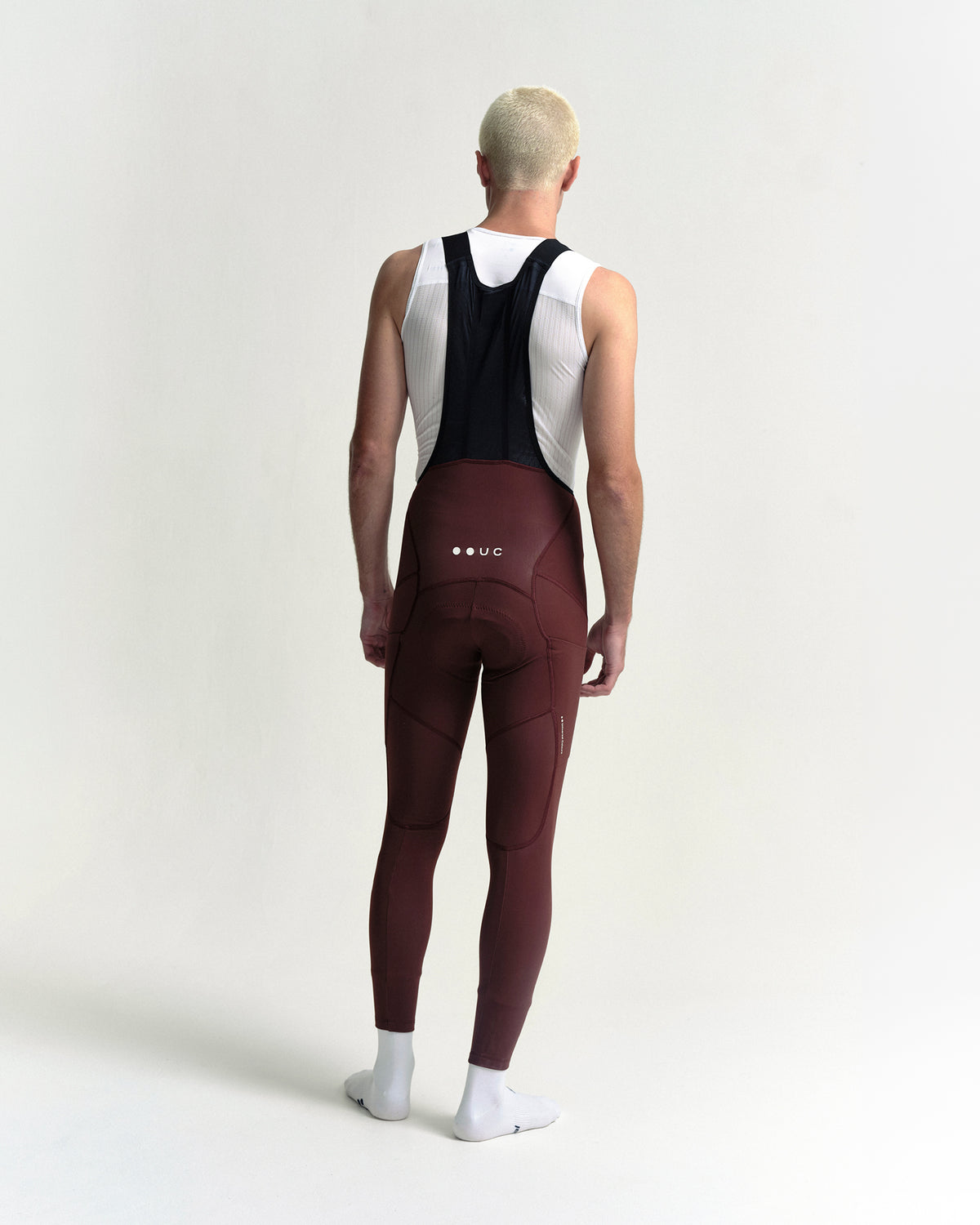 Model wearing the Men's Mono Cargo Bib Tight in Deep Red.