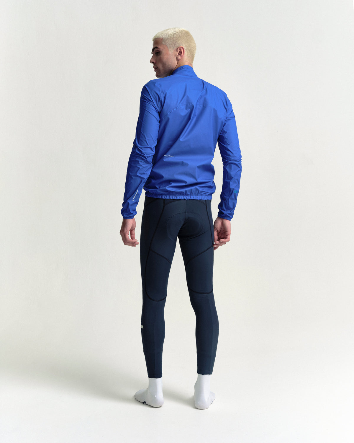 Model wearing the Men's Mono Rain Jacket in Vivid Blue.